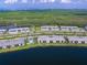 Aerial view showcasing a waterfront community, serene lake, and lush landscaping at 14214 Heritage Landing Blvd # 817, Punta Gorda, FL 33955