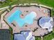 Aerial view showcases resort-style pool, tennis courts, hot tub, and ample lounge seating at 14214 Heritage Landing Blvd # 817, Punta Gorda, FL 33955