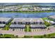 Aerial view showcasing the community with lush landscaping, serene lake, and convenient pool at 14214 Heritage Landing Blvd # 817, Punta Gorda, FL 33955