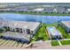 Aerial view showcasing the community pool, lake view, attached garages, and screened balconies at 14214 Heritage Landing Blvd # 817, Punta Gorda, FL 33955