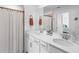 Modern bathroom featuring double sinks, elegant fixtures, and a shower with neutral tones at 14214 Heritage Landing Blvd # 817, Punta Gorda, FL 33955