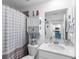 Bright bathroom features modern fixtures, white vanity, and shower with decorative, colorful shower curtain at 14214 Heritage Landing Blvd # 817, Punta Gorda, FL 33955