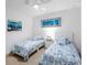 Charming bedroom with two twin beds, ceiling fan, and coastal-themed decor for a serene vibe at 14214 Heritage Landing Blvd # 817, Punta Gorda, FL 33955