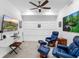 Bright bonus room with a ceiling fan, white trim and a mounted tv over a desk at 14214 Heritage Landing Blvd # 817, Punta Gorda, FL 33955