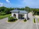Community entrance gate providing security and a grand arrival, with lush landscaping at 14214 Heritage Landing Blvd # 817, Punta Gorda, FL 33955