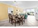 Open dining area with stylish furniture and a view of the adjacent living room and outdoor scenery at 14214 Heritage Landing Blvd # 817, Punta Gorda, FL 33955