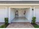 Clean, two-car garage featuring shelving, ample storage space, and painted floors at 14214 Heritage Landing Blvd # 817, Punta Gorda, FL 33955