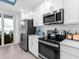 Bright and modern kitchen with stainless steel appliances and white cabinets, offering ample storage and counter space at 14214 Heritage Landing Blvd # 817, Punta Gorda, FL 33955