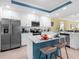 Open concept kitchen with white cabinetry, stainless steel appliances, and a center island with bar seating at 14214 Heritage Landing Blvd # 817, Punta Gorda, FL 33955