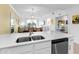 Well-appointed kitchen with stainless steel appliances and a sink overlooking the living and dining areas at 14214 Heritage Landing Blvd # 817, Punta Gorda, FL 33955