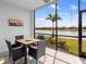 Screened lanai with a table and chairs with an exceptional view of a beautiful lake at 14214 Heritage Landing Blvd # 817, Punta Gorda, FL 33955