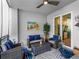 Relaxing lanai featuring comfortable seating, ceiling fan, and bright natural light from sliding glass doors at 14214 Heritage Landing Blvd # 817, Punta Gorda, FL 33955