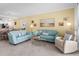 Inviting living room featuring plush seating, stylish decor, and an open layout to the dining area at 14214 Heritage Landing Blvd # 817, Punta Gorda, FL 33955