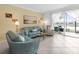Bright living room with plush seating, tile floors, and water views from the sliding glass door at 14214 Heritage Landing Blvd # 817, Punta Gorda, FL 33955