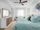 Bright main bedroom featuring white furniture, ceiling fan, and natural light from the window at 14214 Heritage Landing Blvd # 817, Punta Gorda, FL 33955