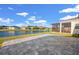Paver patio overlooking a serene pond with neighborhood views and beautiful sky at 14444 59Th E Cir, Bradenton, FL 34211