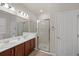 Bright bathroom features dual sinks with chrome fixtures and a glass-enclosed shower at 14444 59Th E Cir, Bradenton, FL 34211