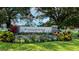 Welcoming Summerfield Park sign surrounded by colorful flowers, lush greenery, and a well-maintained lawn at 14444 59Th E Cir, Bradenton, FL 34211