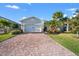Inviting single-story home features a brick paved driveway, lush landscaping, and a two-car garage at 14444 59Th E Cir, Bradenton, FL 34211