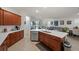 Modern kitchen with stainless steel appliances and an island that overlooks the living area at 14444 59Th E Cir, Bradenton, FL 34211