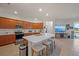 Modern kitchen featuring a large island, stainless steel appliances, and wood cabinetry at 14444 59Th E Cir, Bradenton, FL 34211