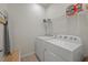 Functional laundry room with washer, dryer, and overhead shelving at 14444 59Th E Cir, Bradenton, FL 34211