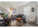 Office with a wooden desk, white chair, bookshelves, a piece of art, and a window at 14444 59Th E Cir, Bradenton, FL 34211