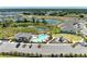 Aerial view of community pool, clubhouse, and playground surrounded by lush landscaping and neighborhood homes at 16109 6Th E Ave, Bradenton, FL 34212