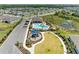 Aerial view of the community playground and pool featuring lush landscaping and nearby neighborhood at 16109 6Th E Ave, Bradenton, FL 34212