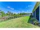 Well-maintained backyard with lush green grass and a wrought iron fence providing privacy and views at 16109 6Th E Ave, Bradenton, FL 34212