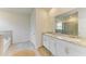 Bright bathroom features a double vanity with granite countertops and a soaking tub at 16109 6Th E Ave, Bradenton, FL 34212