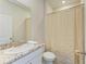 Cozy bathroom featuring a shower with decorative curtain and granite countertop at 16109 6Th E Ave, Bradenton, FL 34212