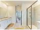 Bright bathroom features a glass shower enclosure and double vanity with granite countertops at 16109 6Th E Ave, Bradenton, FL 34212