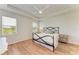 Cozy bedroom with a ceiling fan, wood floors, and two windows for natural light at 16109 6Th E Ave, Bradenton, FL 34212