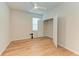 A bedroom with laminate flooring, ceiling fan, window, and open closet for easy storage at 16109 6Th E Ave, Bradenton, FL 34212