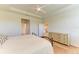 Bright bedroom with trey ceiling, wood floors, a dresser, and two windows for natural light at 16109 6Th E Ave, Bradenton, FL 34212