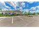 Community clubhouse featuring covered seating area and a pool, with ample parking and beautiful landscaping at 16109 6Th E Ave, Bradenton, FL 34212