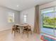 The dining area has tile flooring, an oval wood table with four chairs, and sliding doors that lead to the backyard at 16109 6Th E Ave, Bradenton, FL 34212