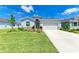 Well-maintained home featuring a landscaped front yard and concrete driveway leading to an attached garage at 16109 6Th E Ave, Bradenton, FL 34212