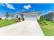 Well-maintained home featuring a landscaped front yard and concrete driveway leading to an attached garage at 16109 6Th E Ave, Bradenton, FL 34212