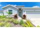 Charming single-Gathering home featuring a landscaped front yard and a welcoming green front door at 16109 6Th E Ave, Bradenton, FL 34212