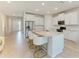 Bright kitchen features stainless steel appliances, granite countertops, a central island with seating, and an open entryway at 16109 6Th E Ave, Bradenton, FL 34212