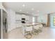 Bright kitchen features an island with granite countertops, modern appliances, and barstool seating at 16109 6Th E Ave, Bradenton, FL 34212