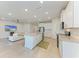 Bright open concept kitchen and living room, features white cabinets, a center island with granite countertops, and appliances at 16109 6Th E Ave, Bradenton, FL 34212