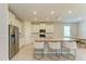 Bright kitchen features an island with granite countertops, modern appliances, and barstool seating at 16109 6Th E Ave, Bradenton, FL 34212