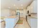 Bright kitchen featuring white cabinets, a center island with granite countertops, and modern stainless steel appliances at 16109 6Th E Ave, Bradenton, FL 34212