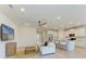 Bright living room flows into a kitchen with a central island, granite countertops and stainless steel appliances at 16109 6Th E Ave, Bradenton, FL 34212