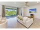 Bright living room features a comfortable sofa, ceiling fan, and sliding glass doors leading to a private outdoor space at 16109 6Th E Ave, Bradenton, FL 34212