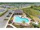 Aerial view of the community pool and lounge area surrounded by lush landscaping and palm trees at 16109 6Th E Ave, Bradenton, FL 34212