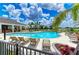 Close-up of the inviting community pool with lots of lounge chairs surrounded by lush landscaping and palm trees at 16109 6Th E Ave, Bradenton, FL 34212